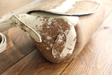 Cowhide Crossbody Saddle Bag side view features the adjustable strap and strap keeper. Shown in color [Cowhide D].