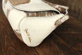 Cowhide Crossbody Saddle Bag side view features the Opal .R. Helm gold logo. Shown in color [Cowhide E].