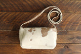 Cowhide Crossbody Saddle Bag back view features a unique pattern of shades of cream, khaki, and chocolate. Shown in color [Cowhide G].