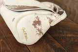 Cowhide Crossbody Saddle Bag side view features the Opal .R. Helm gold logo. Shown in color [Cowhide H].