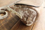 Cowhide Crossbody Saddle Bag side view features the adjustable strap and strap keeper. Shown in color [Cowhide I].