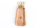 [Rose Gold] leather key case with 4 gold key hooks and gold button closure.
