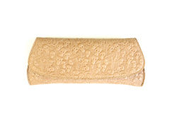 Embossed skull clutch front view.