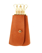 [Saddle Tan] George Key Case. Double-sided leather for durability with 4 gold key hooks and a gold button closure. Fits standard sized keys inside case, while car FOB hangs outside.